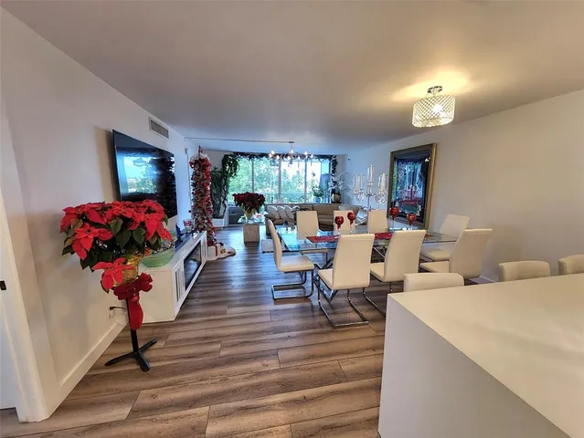 a living room with furniture flowers and a chandelier