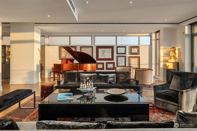 a living room with furniture and a floor to ceiling window