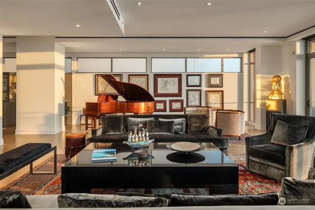 a living room with furniture and a floor to ceiling window