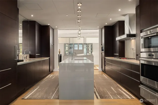 a view of a kitchen with living room and stainless steel appliances