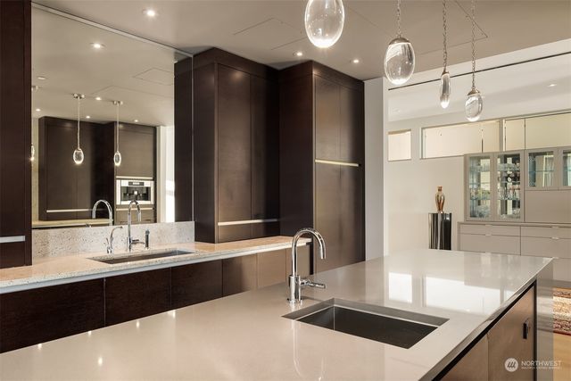 a bathroom with a sink a large mirror and a shower