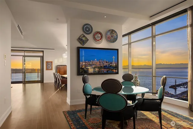 a dining room with furniture and wooden floor