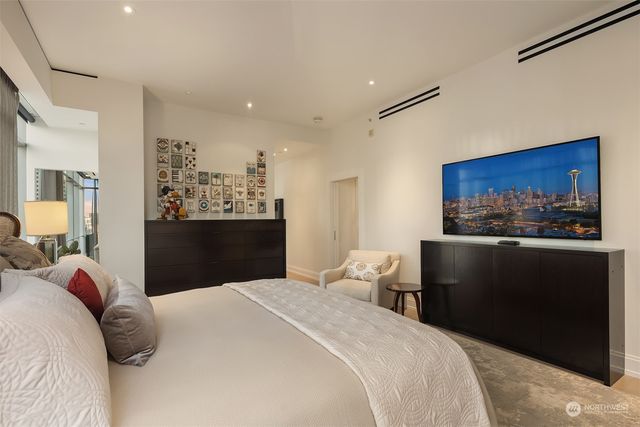 a bedroom with a bed and cabinet