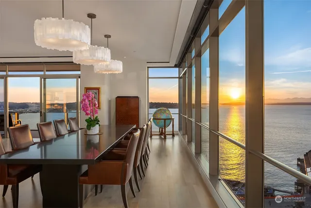 a dining room with furniture a chandelier and wooden floor