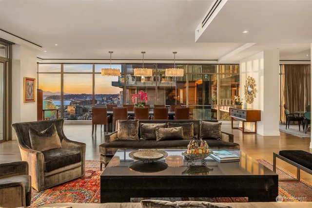 a living room with furniture and a floor to ceiling window