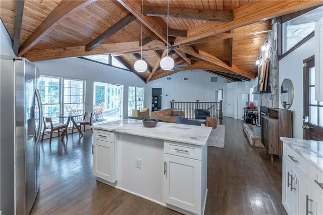 a kitchen with lots of counter top space and a dining table with wooden floor
