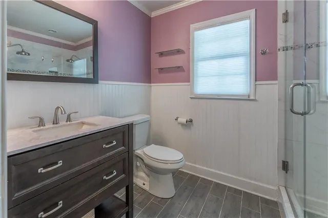 a bathroom with a granite countertop sink a toilet and a mirror