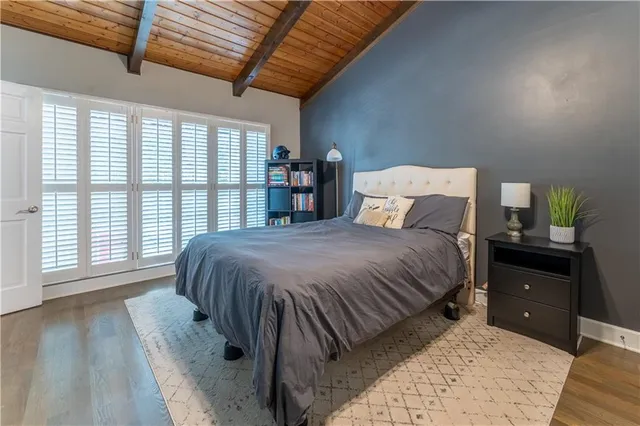 a bed sitting in a bedroom next to a window