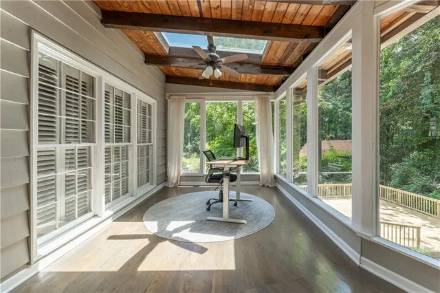 a room with pool table and windows