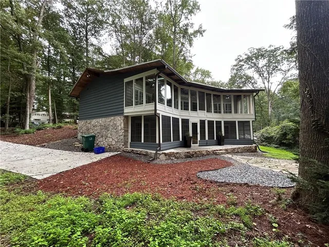 a kitchen with granite countertop wooden cabinets a sink and dishwasher