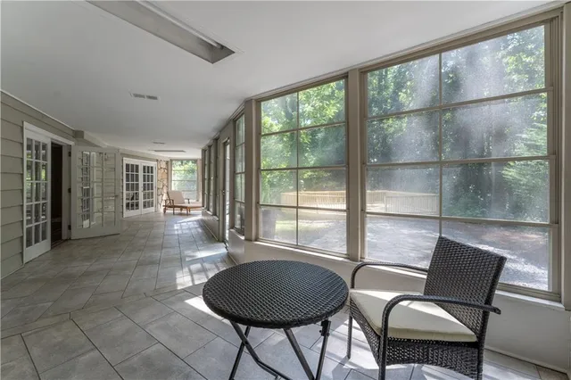 a view of a room with furniture and floor to ceiling window