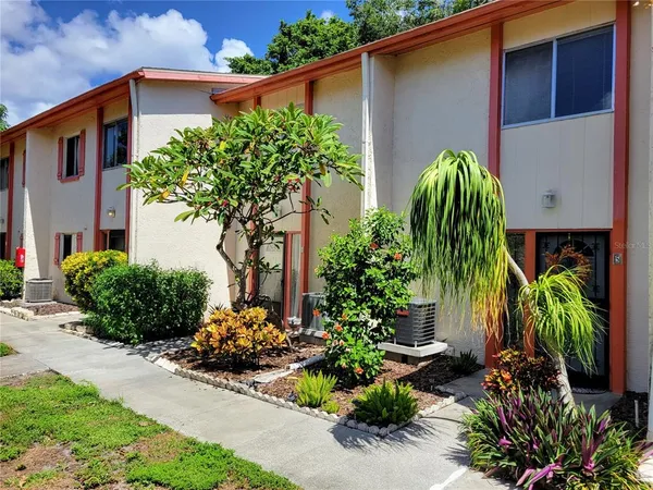a front view of a house with a yard and a garden