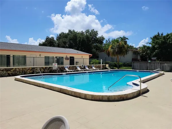 a view of a swimming pool and lounge chairs