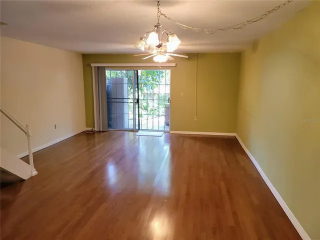 a view of wooden floor and windows in a room