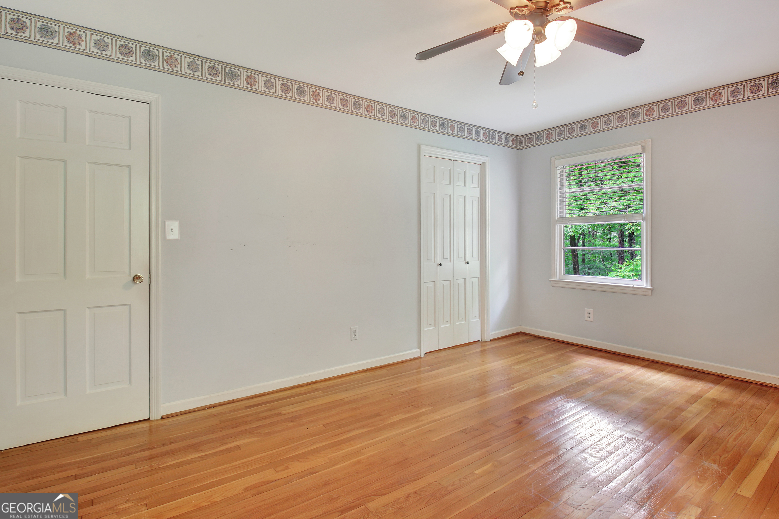 717 Tyrone Road Tyrone, GA 30290 - Photo 29 of 58 a view of an empty room with wooden floor and a window
