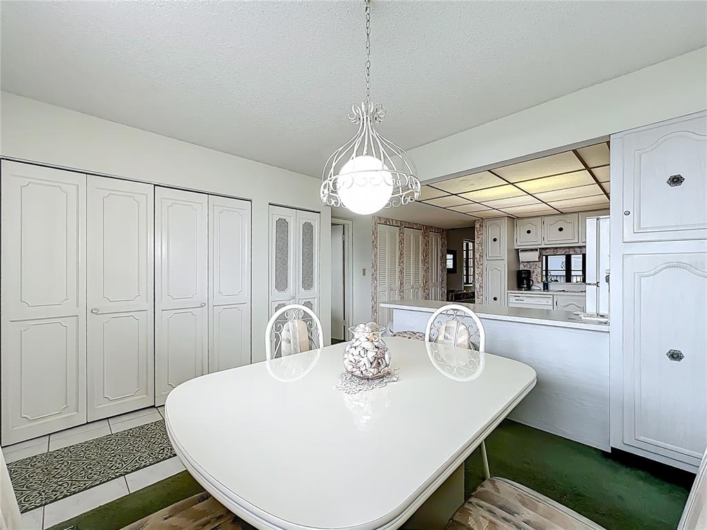 17580 Gulf Boulevard, Unit 219 Redington Shores, FL 33708 - Photo 15 of 47 a kitchen with a table and chairs in it