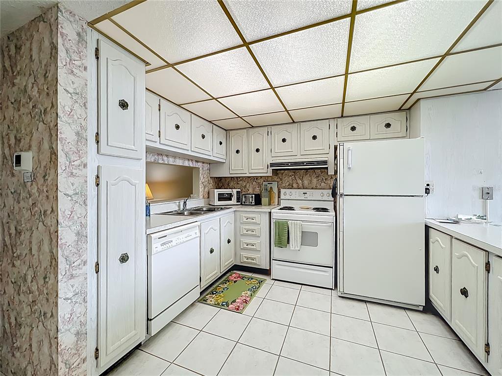 17580 Gulf Boulevard, Unit 219 Redington Shores, FL 33708 - Photo 16 of 47 a kitchen with cabinets and stainless steel appliances