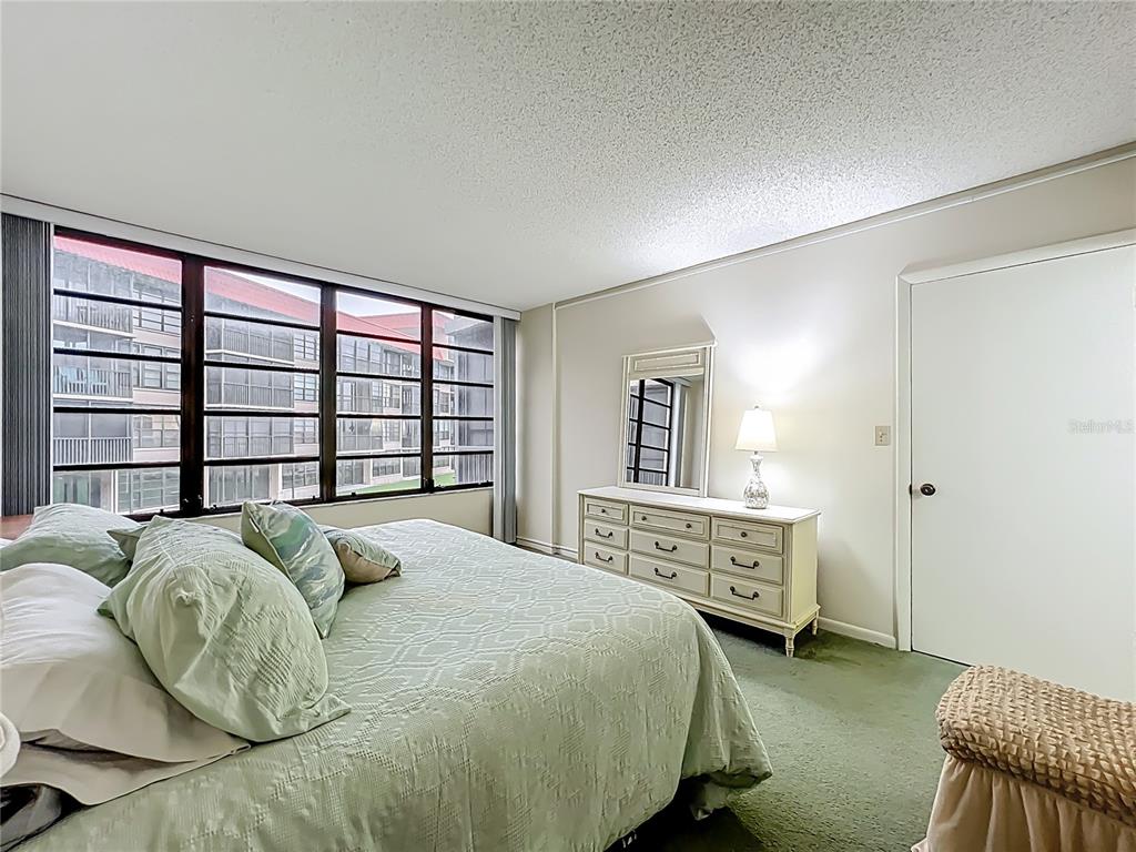 17580 Gulf Boulevard, Unit 219 Redington Shores, FL 33708 - Photo 23 of 47 a bed sitting in a bedroom next to a window