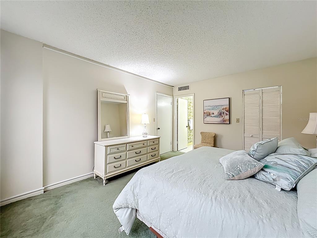 17580 Gulf Boulevard, Unit 219 Redington Shores, FL 33708 - Photo 25 of 47 a bedroom with a bed and a dresser