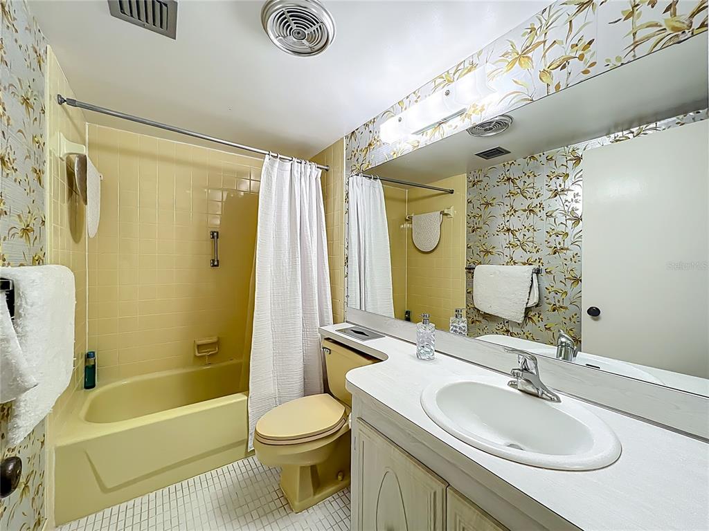 17580 Gulf Boulevard, Unit 219 Redington Shores, FL 33708 - Photo 27 of 47 a bathroom with a sink a toilet and shower