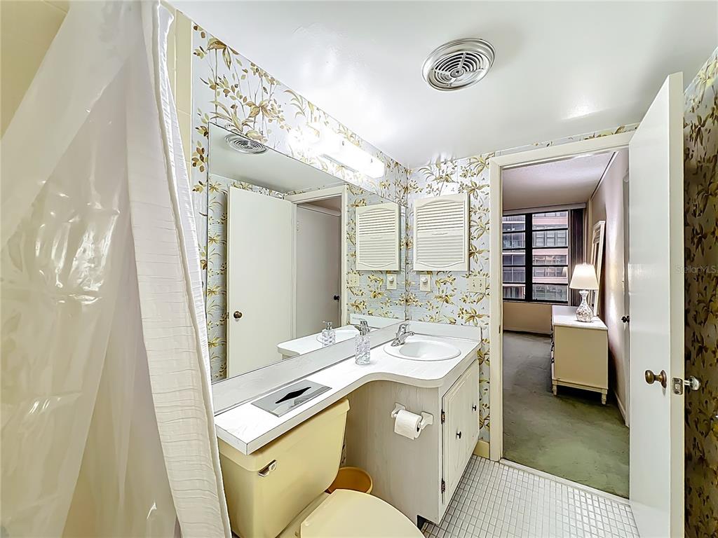 17580 Gulf Boulevard, Unit 219 Redington Shores, FL 33708 - Photo 28 of 47 a spacious bathroom with a double vanity sink a mirror and a shower