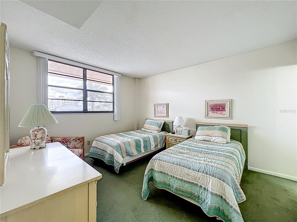 17580 Gulf Boulevard, Unit 219 Redington Shores, FL 33708 - Photo 29 of 47 a bedroom with two beds and a window