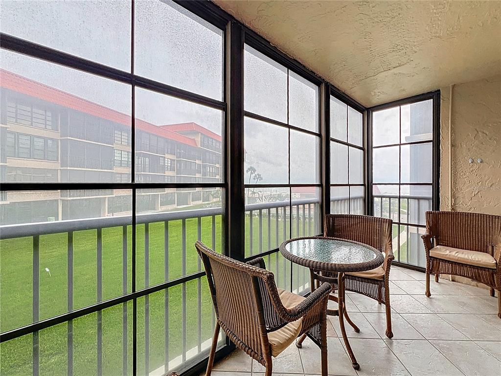 17580 Gulf Boulevard, Unit 219 Redington Shores, FL 33708 - Photo 3 of 47 a view of a chairs and table in the balcony