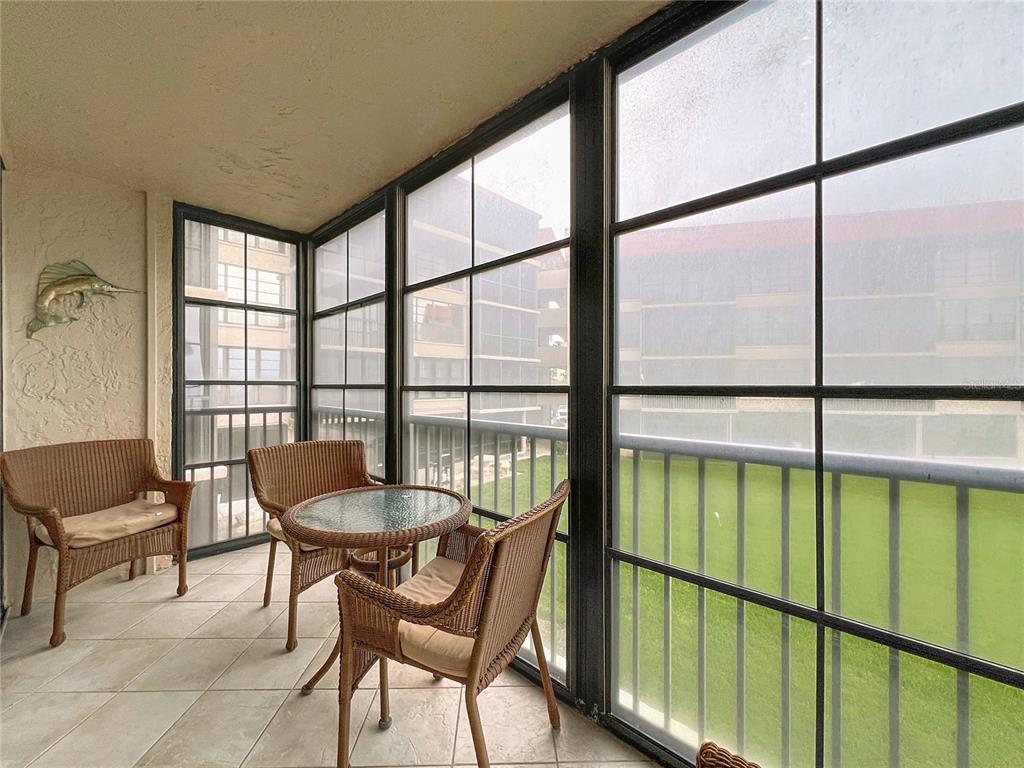 17580 Gulf Boulevard, Unit 219 Redington Shores, FL 33708 - Photo 35 of 47 a living room with a table and chairs