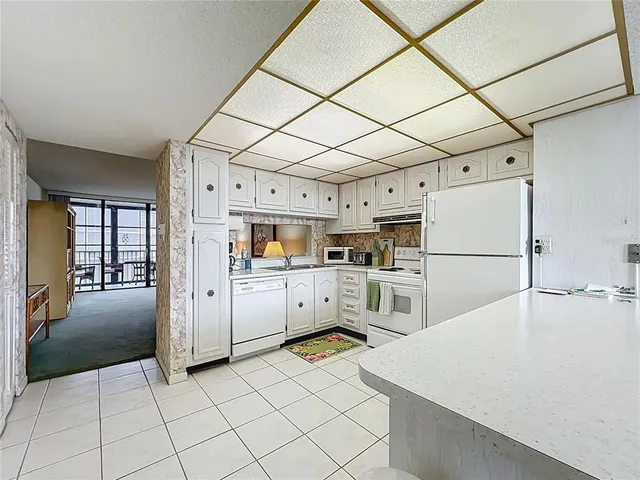 a kitchen with cabinets and wooden floor
