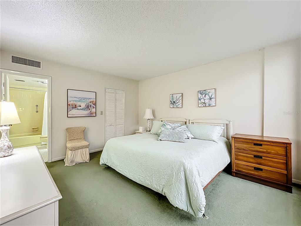 17580 Gulf Boulevard, Unit 219 Redington Shores, FL 33708 - Photo 8 of 47 a bedroom with a bed and lamp