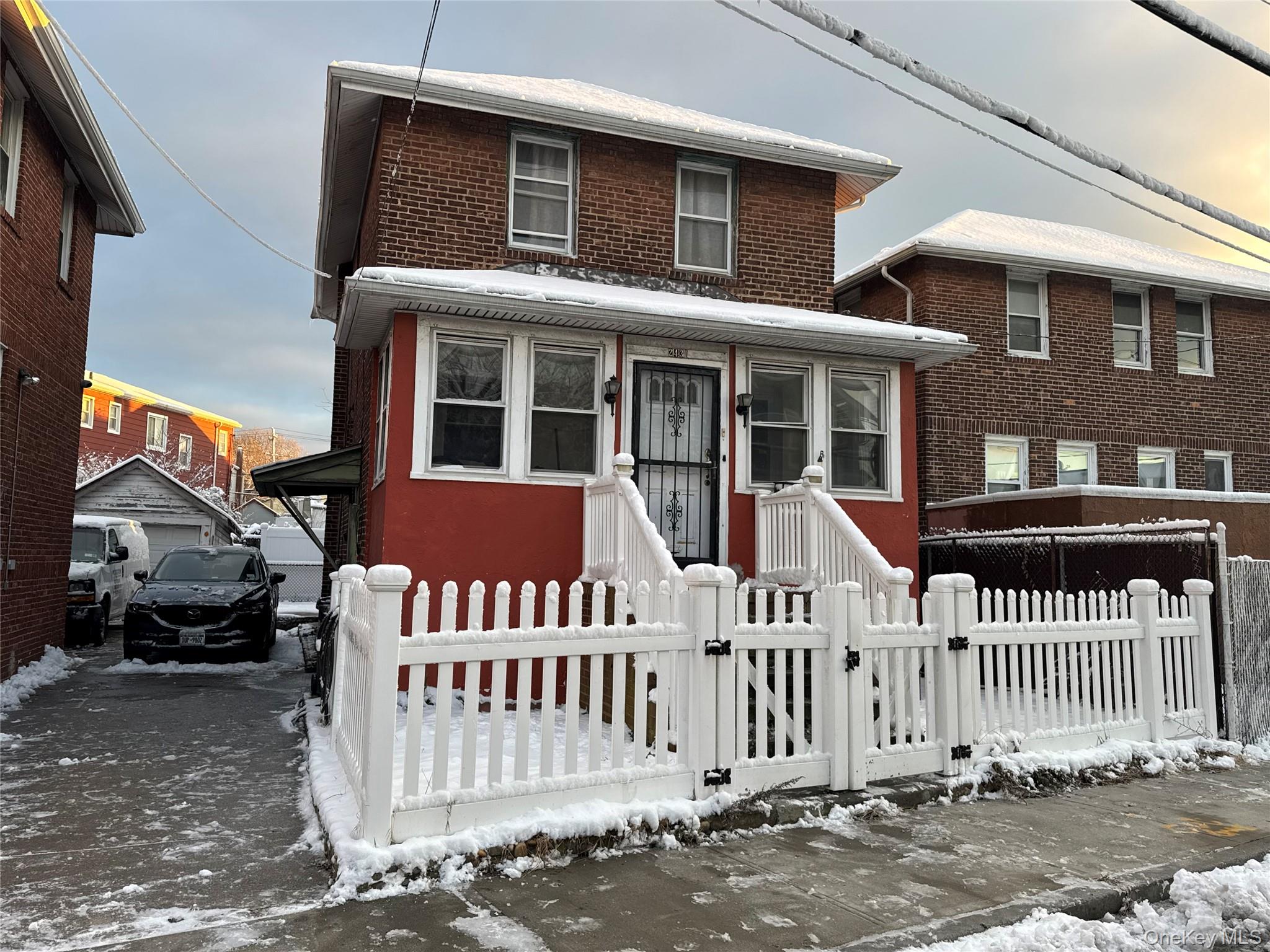 24-31 Deerfield Road Queens, NY 11691 - Photo 1 of 25 View of front of home with a gate, brick siding, and a fenced front yard