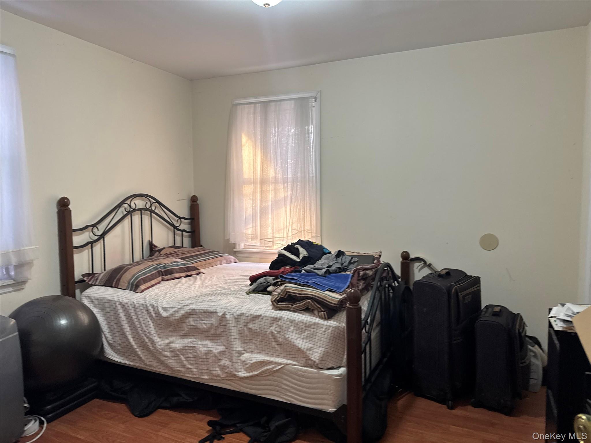 24-31 Deerfield Road Queens, NY 11691 - Photo 18 of 25 Bedroom with dark wood-style flooring