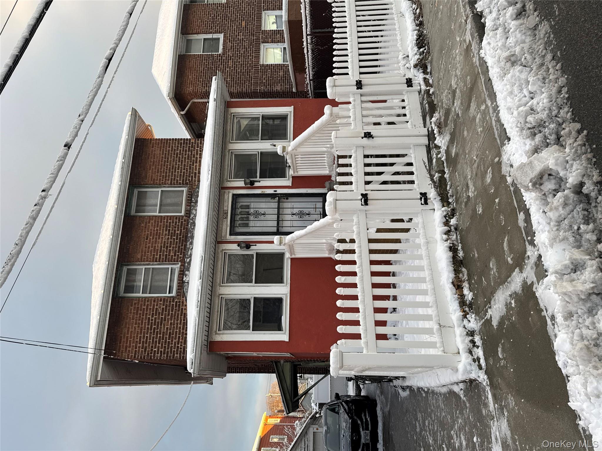 24-31 Deerfield Road Queens, NY 11691 - Photo 2 of 25 View of front of house with brick siding, a gate, and a fenced front yard