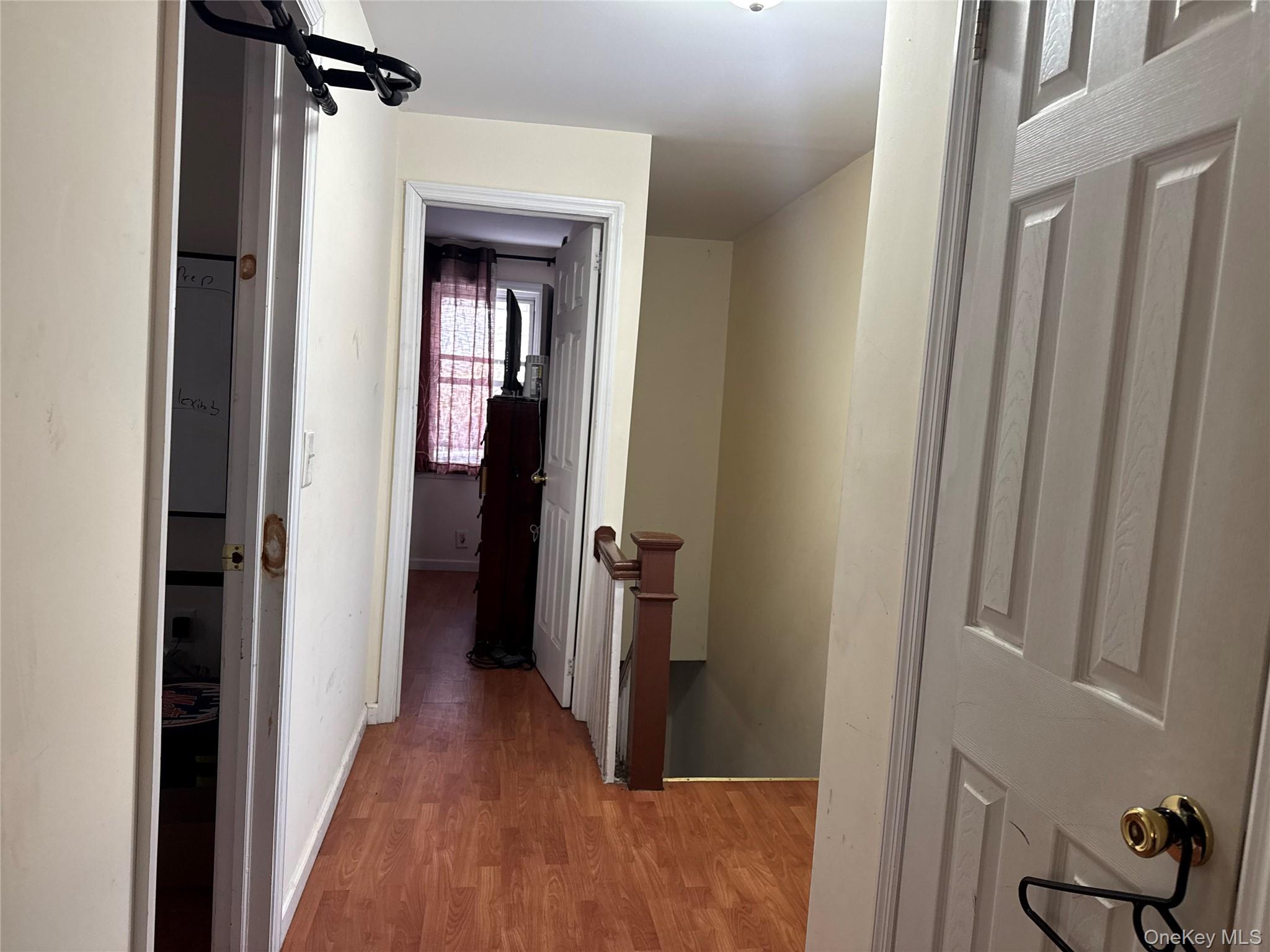 24-31 Deerfield Road Queens, NY 11691 - Photo 10 of 25 Hallway featuring an upstairs landing and wood finished floors