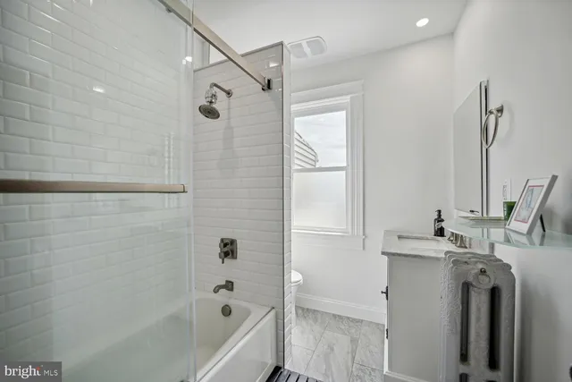 a bathroom with a tub sink and mirror