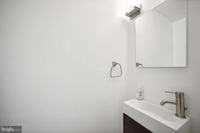 a bathroom with a sink and mirror