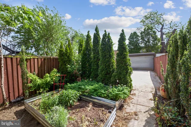 a view of a deck with furniture and a backyard