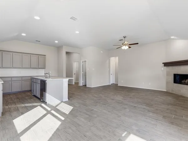 a view of kitchen with stainless steel appliances granite countertop a stove top oven and cabinets