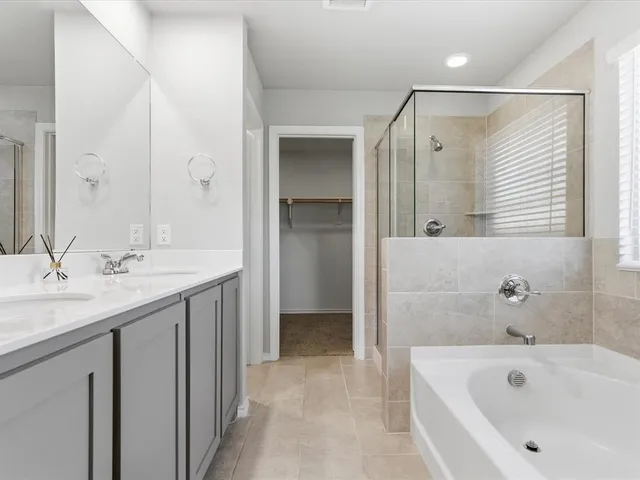 an empty room with a window and a ceiling fan