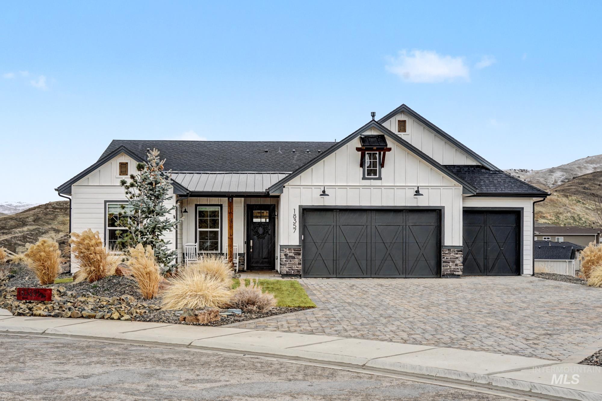 18357 North Burnt Car Way Boise, ID 83714 - Photo 2 of 48 Modern farmhouse style home featuring board and batten siding, a shingled roof, a mountain view, decorative driveway, and covered porch
