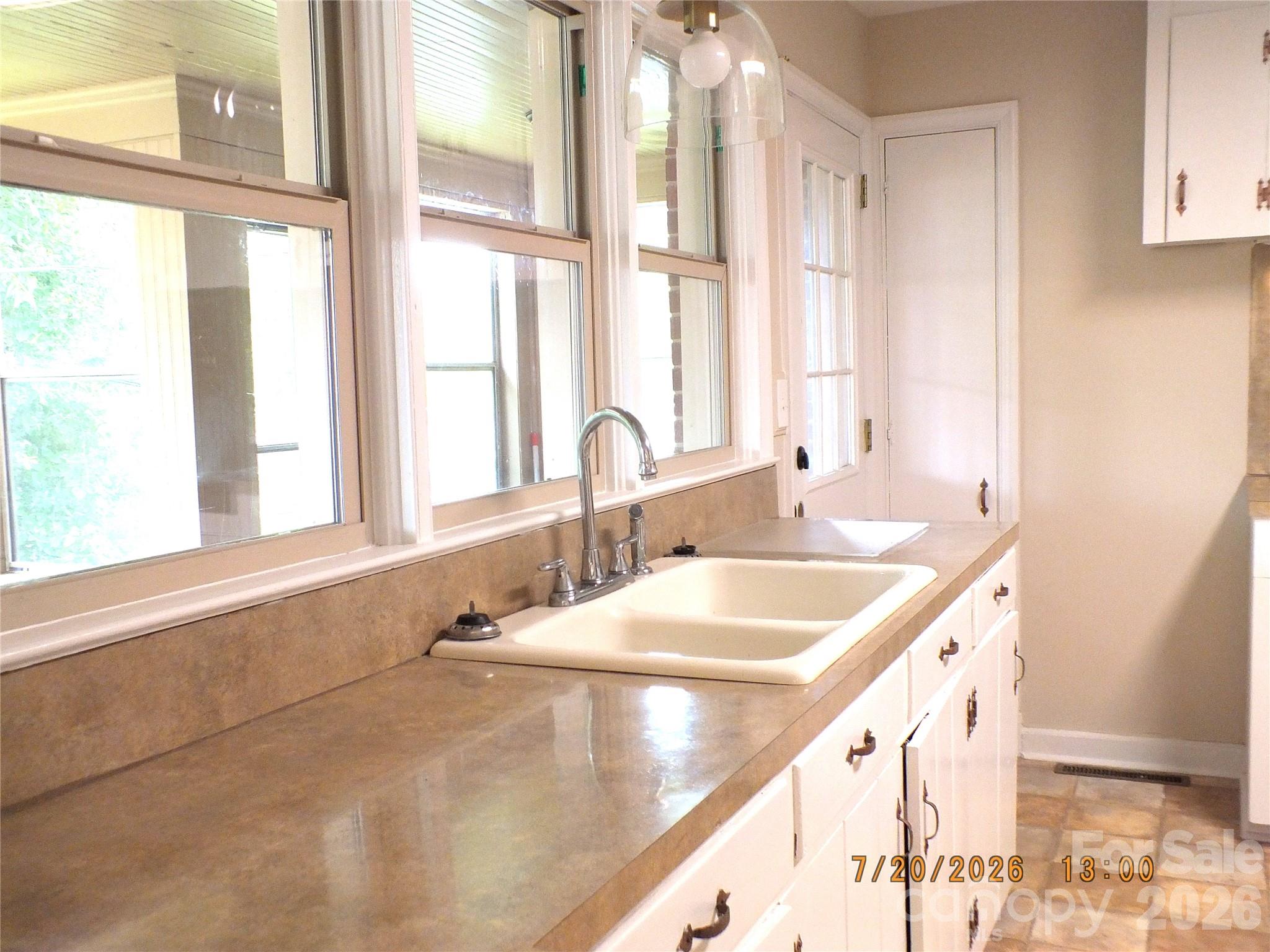 414 West Springs Street Lancaster, SC 29720 - Photo 10 of 22 a bathroom with a granite countertop sink and a large window