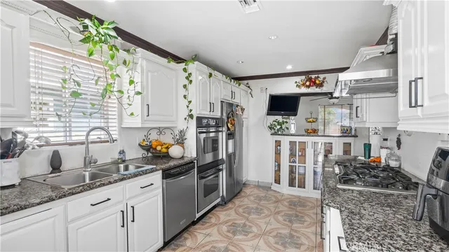 a kitchen with refrigerator and window