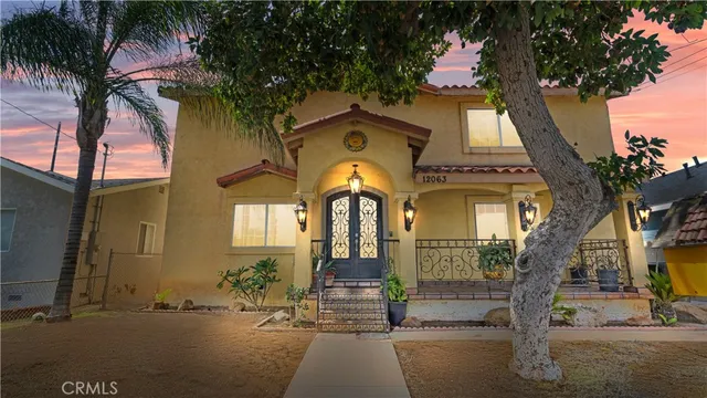 a front view of a house with a garden