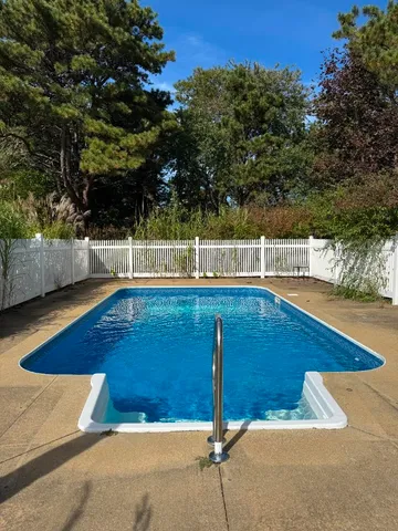 a view of a swimming pool with a lounge chairs