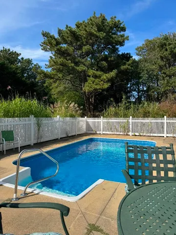 a view of swimming pool with an outdoor seating