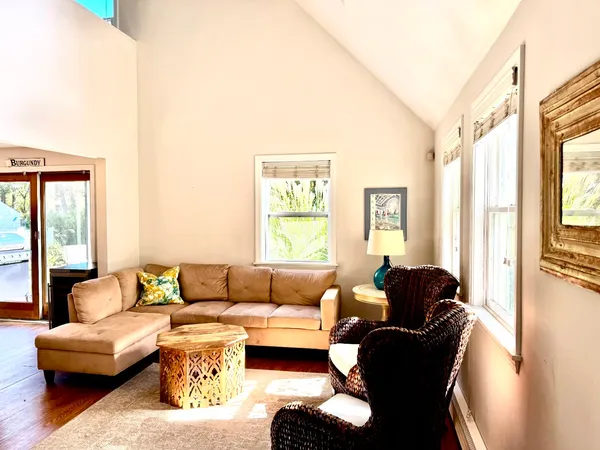 a kitchen with stainless steel appliances granite countertop a stove a sink a microwave a dining table and chairs with wooden floor