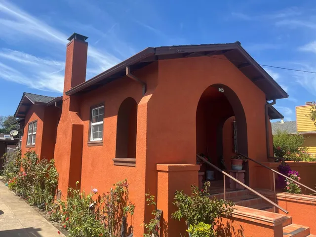 a front view of a house with a garden