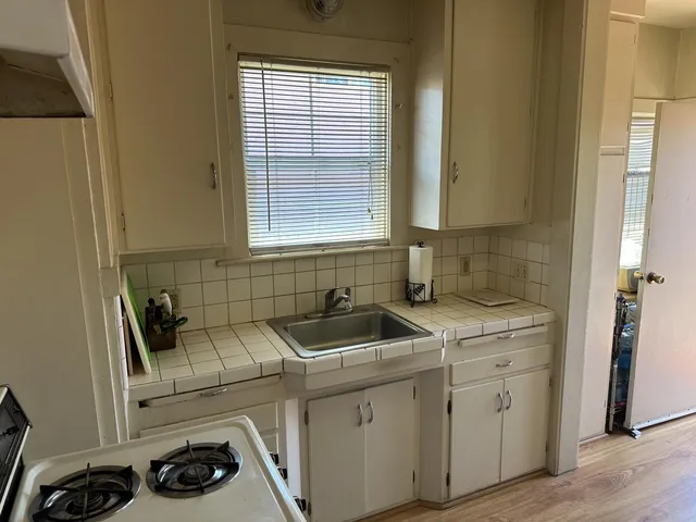 a kitchen with sink and cabinets