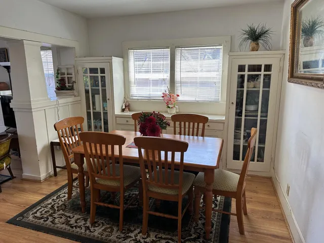 a view of a dining room with furniture window and wooden floor