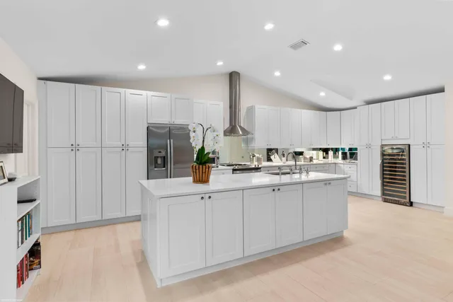 a kitchen with stainless steel appliances a sink stove and cabinets